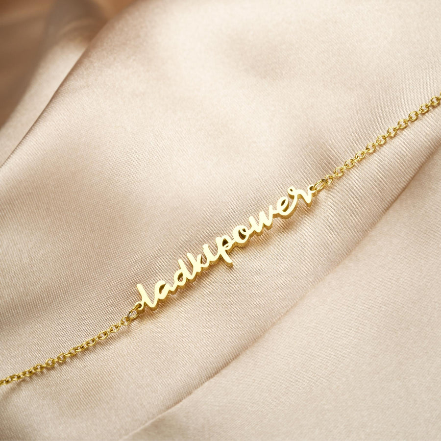 ZUDO-LadkiPower-Necklace-bgm-Gold-flatlay-fabric-side-angle
